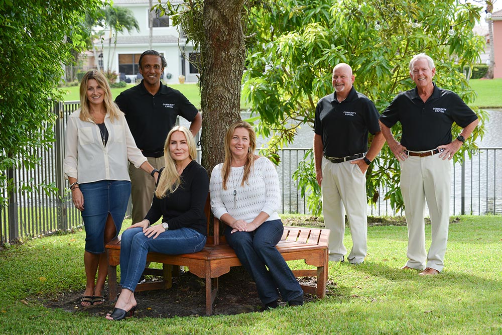 Community Capital Holdings Team in Florida Yard Under a Tree