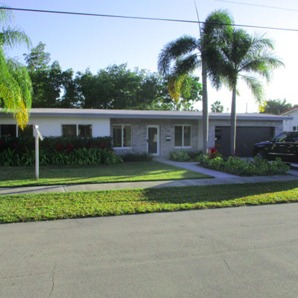Street View of Residential Florida Home with Driveway, Palm Trees with a Front Door and Windows