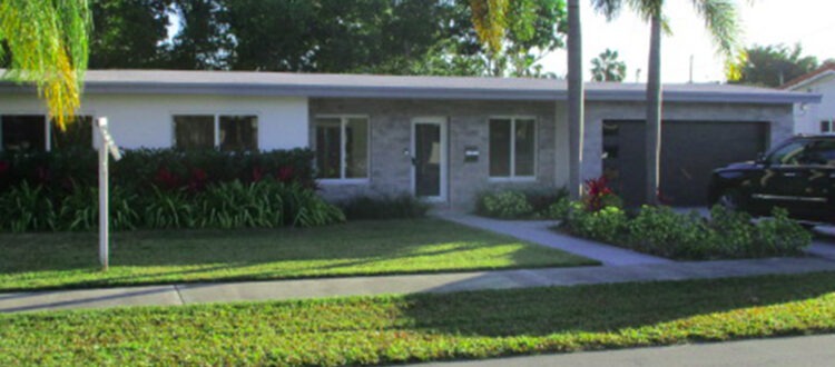 Street View of Residential Florida Home with Driveway, Palm Trees with a Front Door and Windows