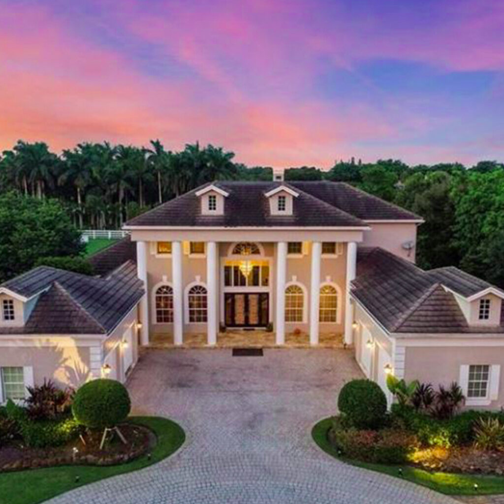 Luxury Residential Investment property with Four Garages and a Grand Entrance with stone columns in South Florida at Sunset