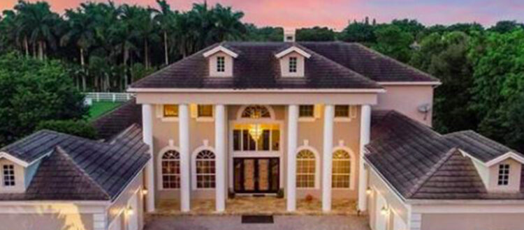 Luxury Residential Investment property with Four Garages and a Grand Entrance with stone columns in South Florida at Sunset