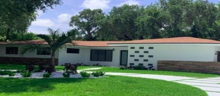 Residential Investment Property with Large Modern Driveway and Trees on a Sunny Day in South Florida