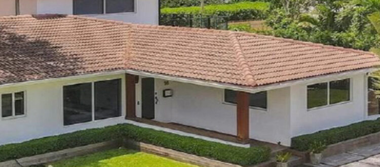 Exterior View of White and Brown Residential Property with Grassy Yard in South Florida