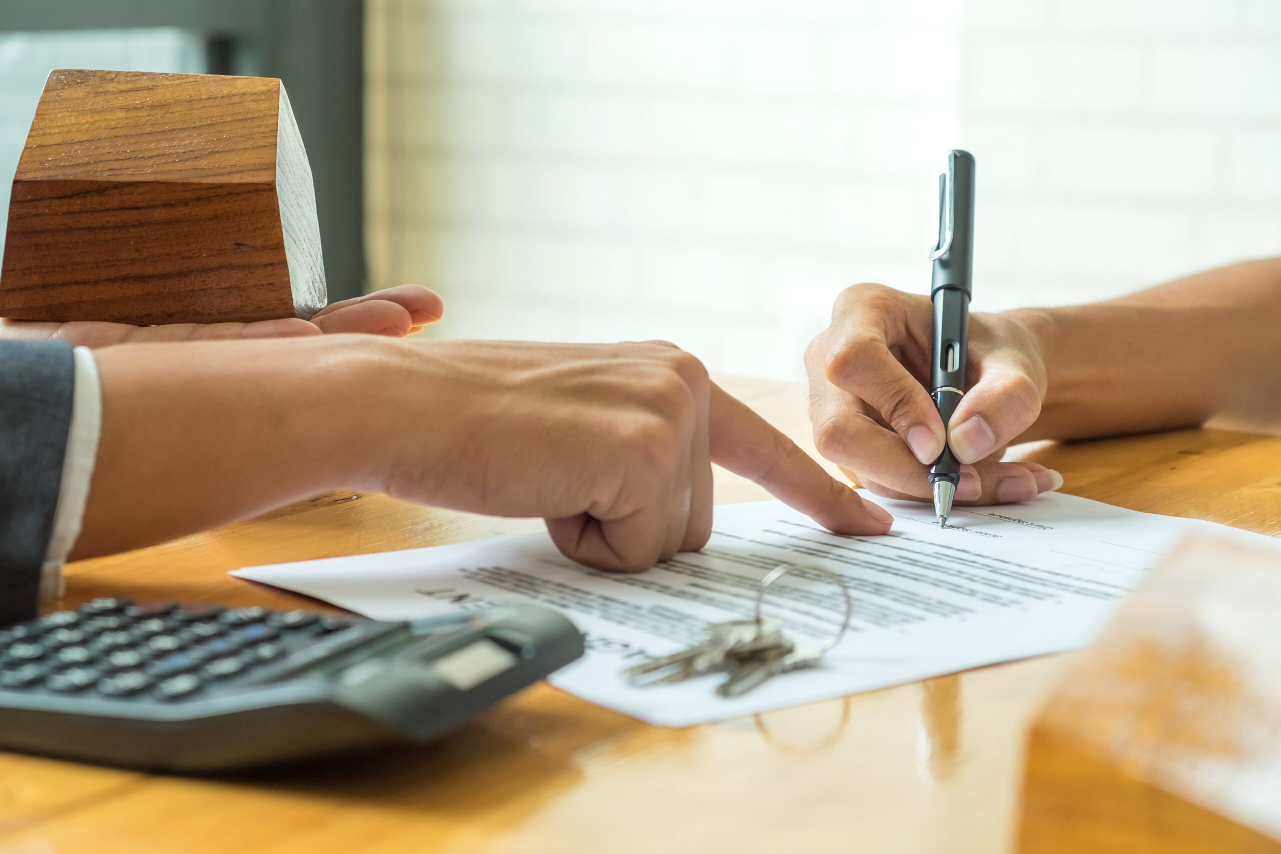 Buyers Signing a Home Purchase Agreement from a Broker South Florida