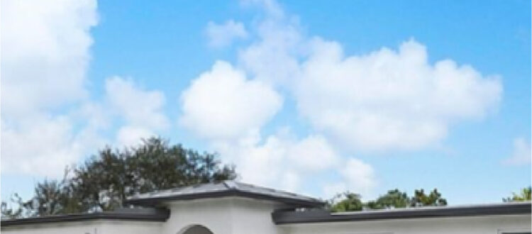 White Residential House with Arched Doorway and Large Driveway in South Florida