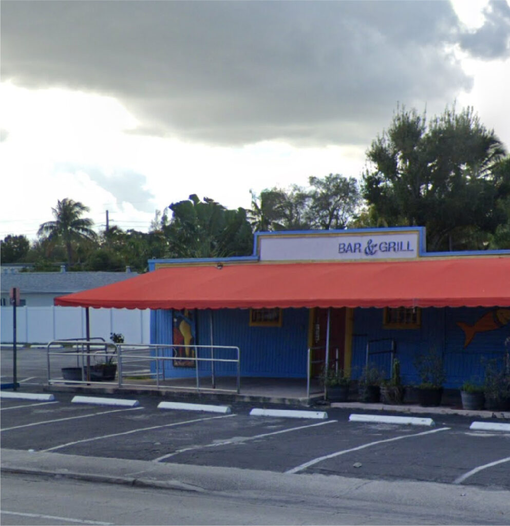 Blue Building with Red Awning Commercial Property in Florida with Parking Lot