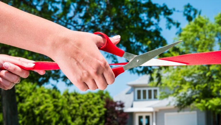 scissors cutting red tape