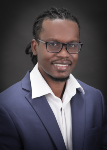 Headshot of Atiba. He is the Senior Business Development Manager & Analyst at Community Capital Holdings in South Florida. Atiba is wearing a blazer and button shirt.
